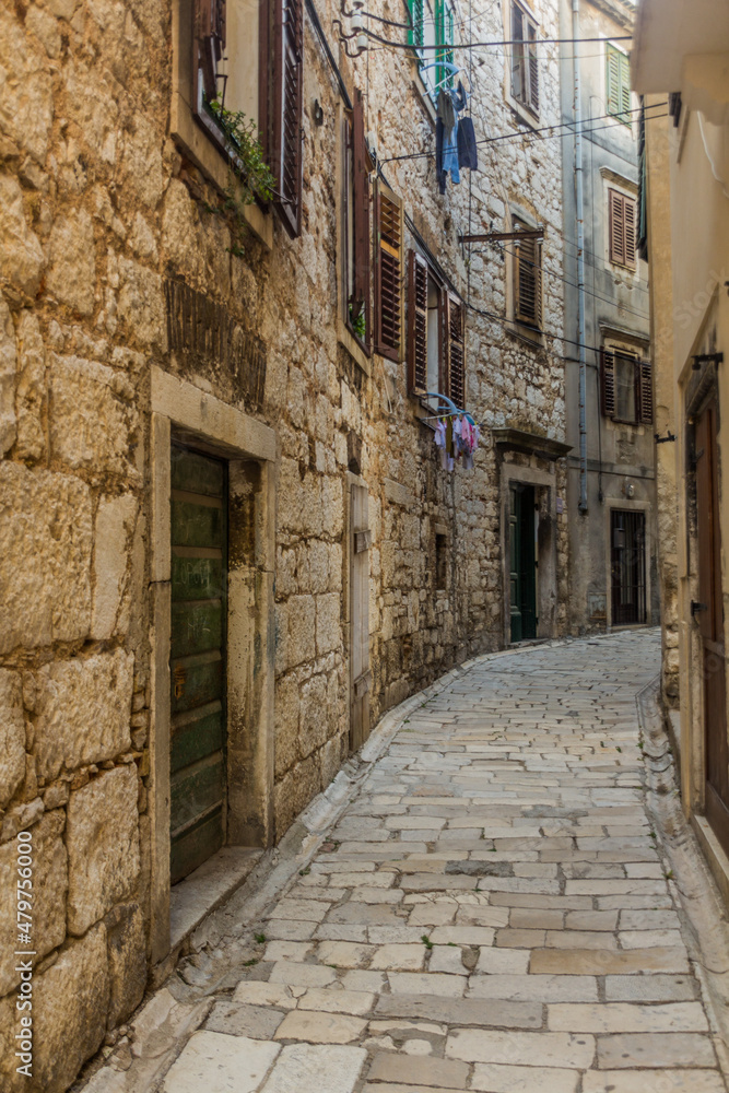 Narrow stone alley in Sibenik, Croatia