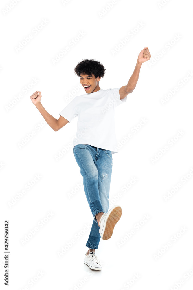 full length view of african american man in jeans and t-shirt dancing on white. full length view of african american man in jeans and t-shirt dancing on white.
