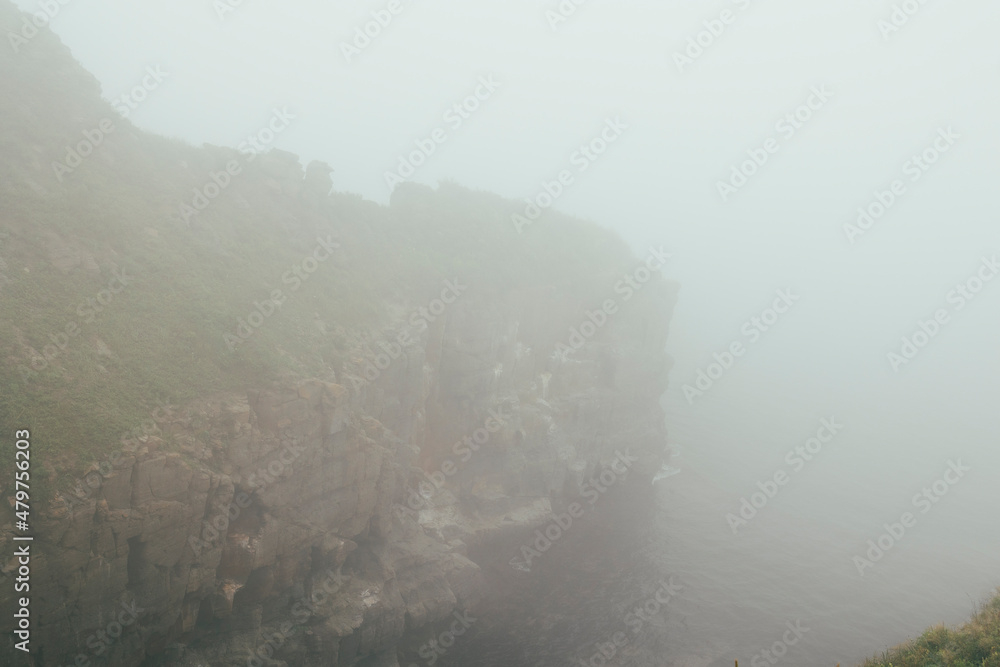 Ocean waves and coastal sea fog around the rocks, cloudy weather, storm Ocean waves and coastal sea fog around the rocks, cloudy weather, storm
