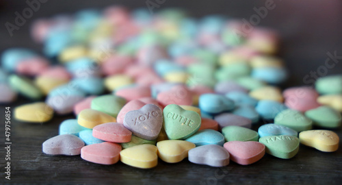 Colorful candy hearts with loving messages are a traditional treat on Valentine`s Day. photo
