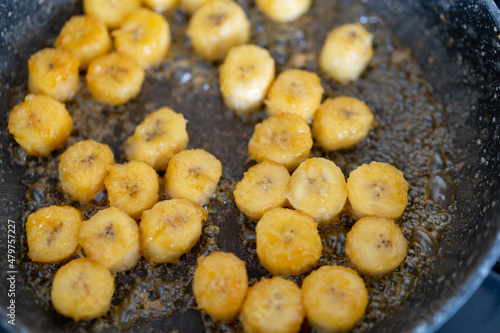 Process of cooking caramelized banana in a frying pan at home Selective focus