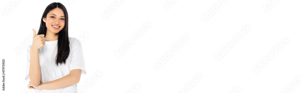 pleased asian woman showing thumb up while looking at camera isolated on white, banner. pleased asian woman showing thumb up while looking at camera isolated on white, banner.