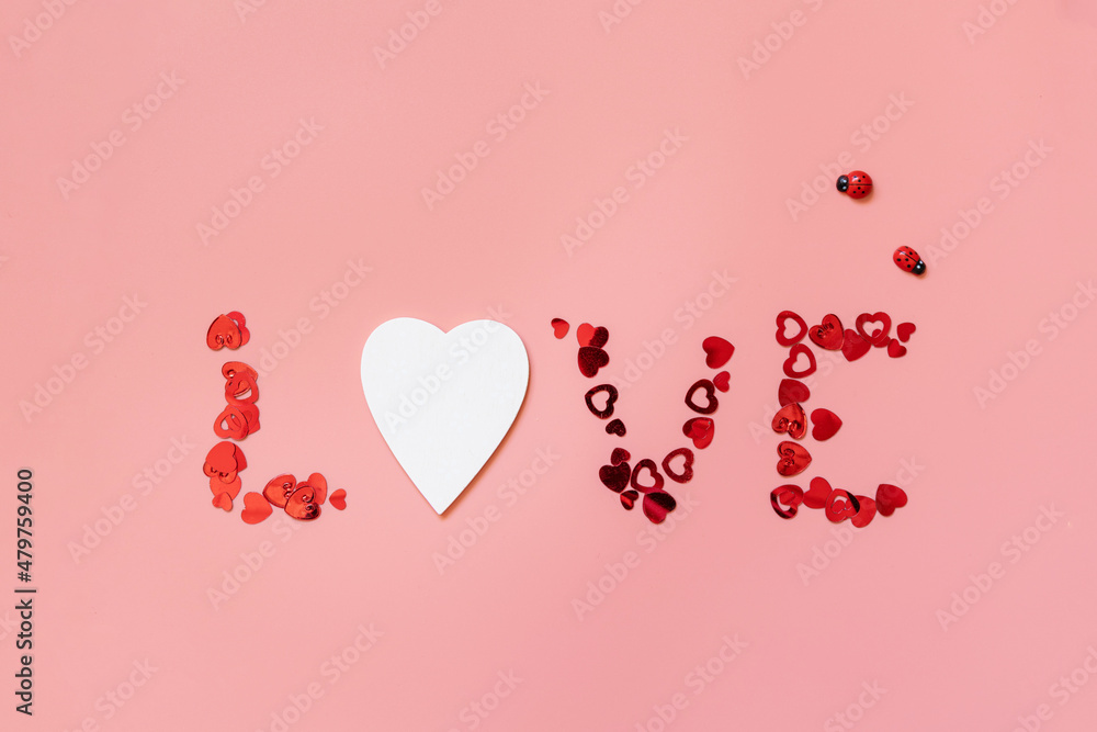Valentines, love and wedding concept. Lettering love on pink background. Flat lay, top view.