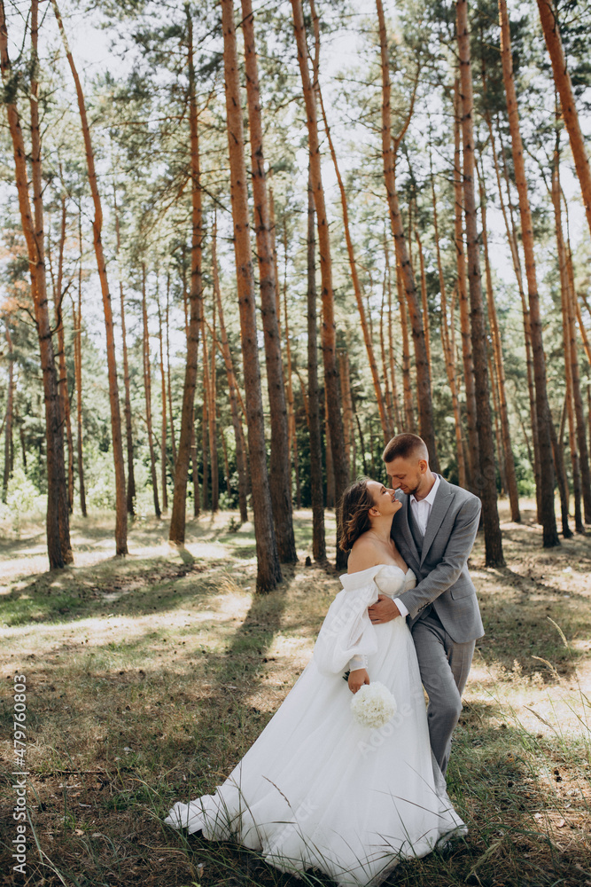 Young couple having wedding photo session in forest on their wedding day Young couple having wedding photo session in forest on their wedding day