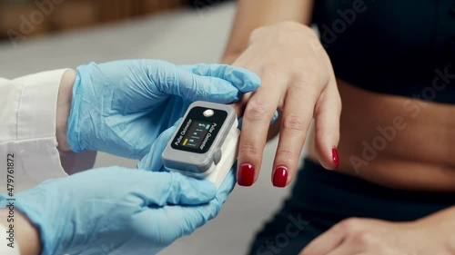 Pulse oximeter at home or clinic show oxygen saturation level in blood and heart rate. Finger pulseoximeter monitoring vital sign during virus infection of the lungs. Pensioner corona virus covid 19 photo