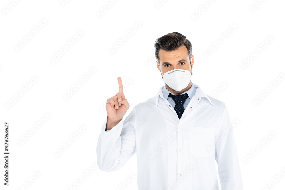 doctor in white coat and medical mask looking at camera and pointing with finger on white. doctor in white coat and medical mask looking at camera and pointing with finger on white.