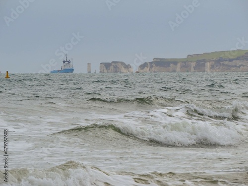 waves crashing with Old Harry Rocks standing tall on Handfast Point at the southern end of Studand Bay one of the most famous landmarks on the south coast in the background
 photo