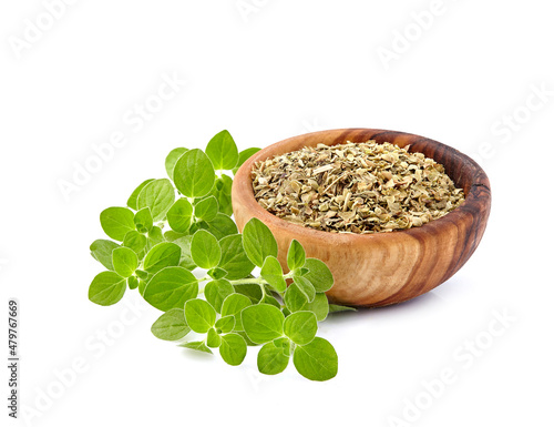 Oregano or marjoram leaves isolated in wooden bowl on white background. Oregano fresh and dry.