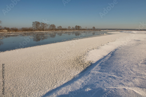 winter landscape. morning frost and sun. ice drift on the river. the branches of plants are covered with white frost