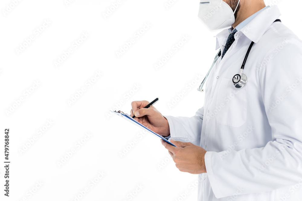 partial view of doctor in medical mask writing on clipboard isolated on white. partial view of doctor in medical mask writing on clipboard isolated on white.