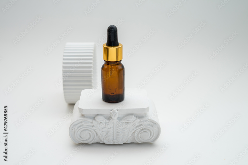 Cosmetic jar of facial essence stands on the podium. Cosmetics on a white background. Mockup Body oil bottle Cosmetic jar of facial essence stands on the podium. Cosmetics on a white background. Mockup Body oil bottle