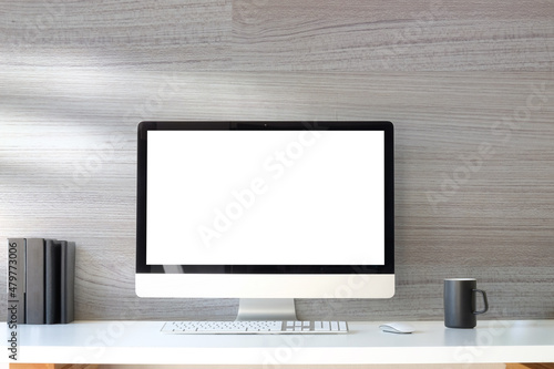 Minimal workplace with computer pc, coffee cup and book on white table. Blank screen for your advertising text.