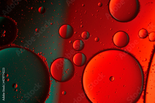abstract background. drops of oil on water, red and green color. macro