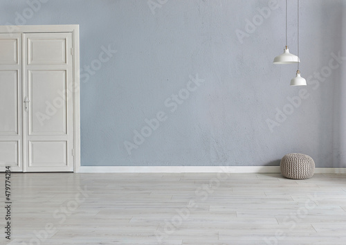 Grey stone wall background with white wooden door, lamp carpet and home style, poster decoration room interior. photo