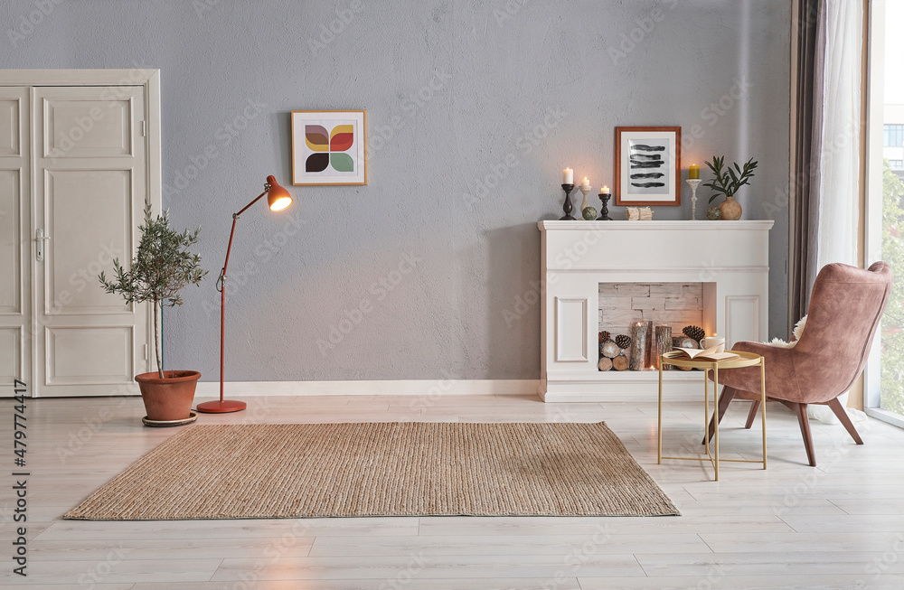 Fototapeta premium Modern room concept interior style, chair fireplace frame wicker carpet decoration, grey stone wall background.