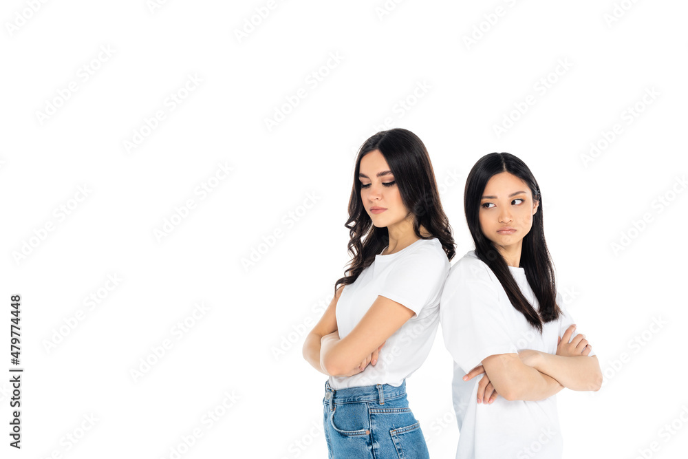 offended interracial women standing back to back with crossed arms isolated on white. offended interracial women standing back to back with crossed arms isolated on white.