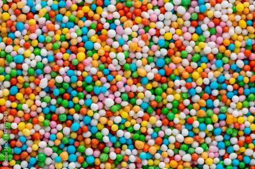 Thousands sprinkles tiny sugar beads for decorating cakes and desserts background.