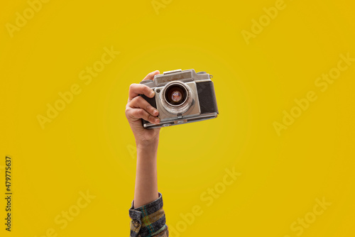 Photographer holding a vintage camera in closeup view hand