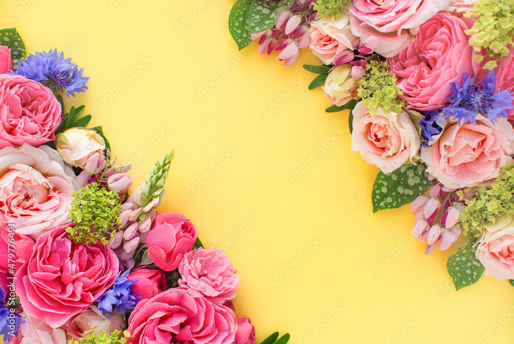 Composition of beautiful flowers, on yellow background. Flowers spring or summer frame. Colorful flowers festive background. Floral concept
