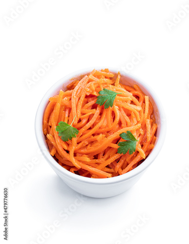 Delicious spicy carrot salad in ceramic bowl isolated on white