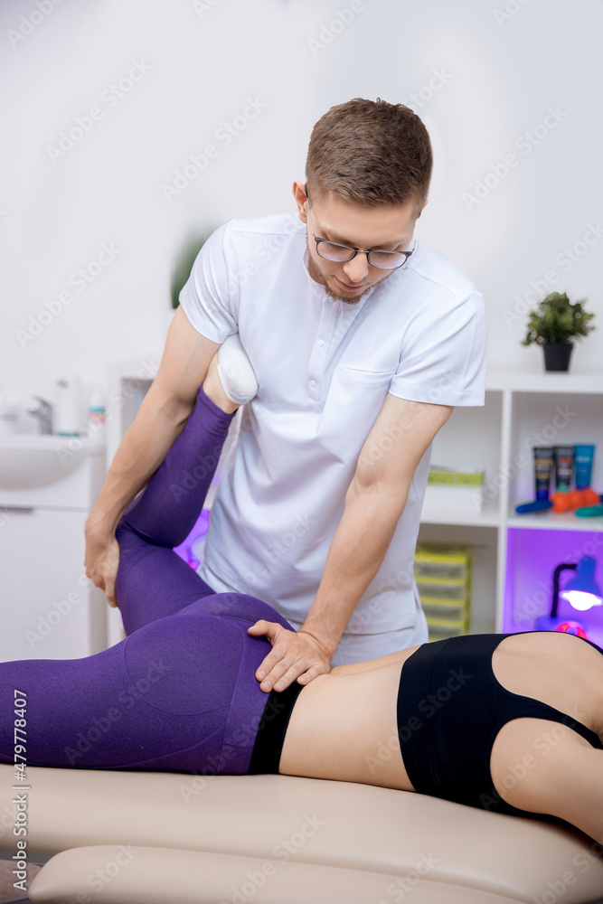 Osteopath therapist working with legs muscle after workout. Concept sports massage for athlete woman Osteopath therapist working with legs muscle after workout. Concept sports massage for athlete woman