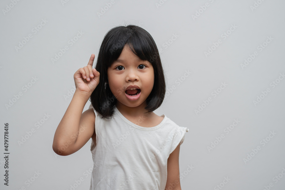 Portrait of Asian child 5 year old and to collect hair and Place her hands on her chin and make thinking pose on isolated white background, She is Happiness, radiance in youth, Education Concept Portrait of Asian child 5 year old and to collect hair and Place her hands on her chin and make thinking pose on isolated white background, She is Happiness, radiance in youth, Education Concept