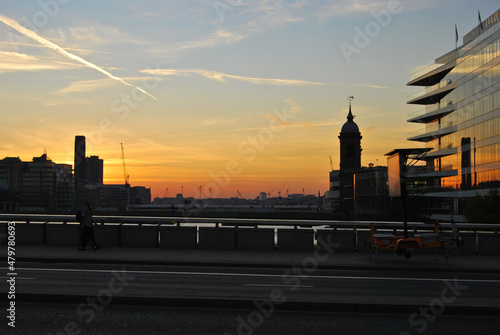 Urban sunset with silhouette and red sky photo