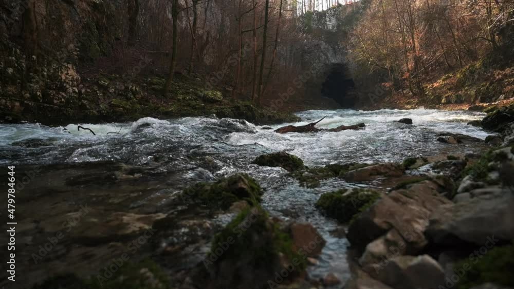 Water flowing over rocks in Rakov Skocjan. A natural bridge in Slovenia. Shot in 60 and 120fps for slow-motion. The rocks are covered in moss, Water flowing over rocks in Rakov Skocjan. A natural bridge in Slovenia. Shot in 60 and 120fps for slow-motion. The rocks are covered in moss,