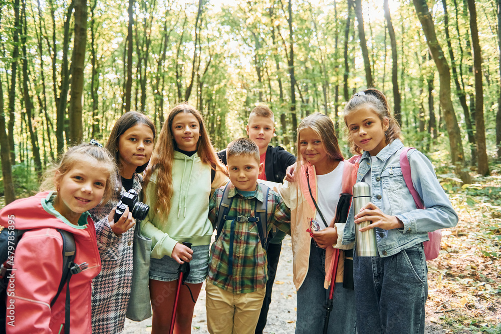 Standing together. Kids in green forest at summer daytime together Standing together. Kids in green forest at summer daytime together