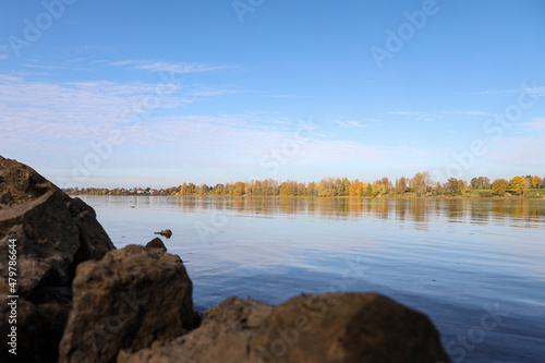 Autumn landscape view near river with autumn trees. © Artūrs Stiebriņš