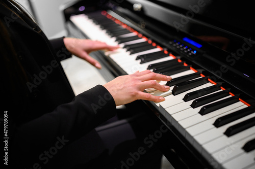 Close up of a musician playing a piano keyboard