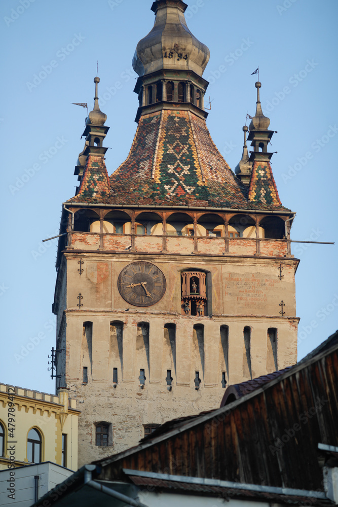 The medieval clock tower in the Transylvanian town of Sighisoara in a sunny autumn morning.