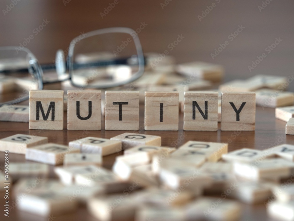 Ταπετσαρία mutiny concept represented by wooden letter tiles on a wooden table with glasses