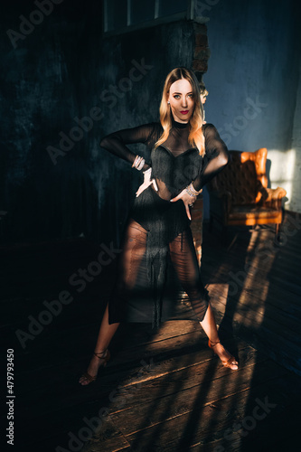 Portrait of beautiful woman professional ballroom dancer in loft studio. Sport life concept. Passion and emotional dance.