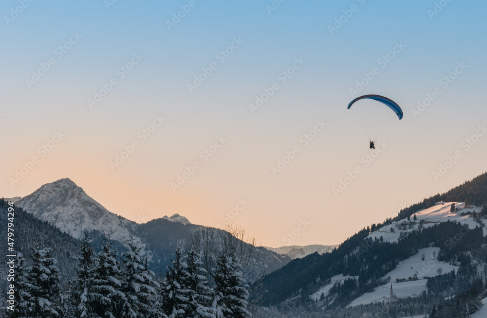 paragliding sunset over the mountains