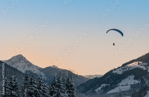 paragliding sunset over the mountains