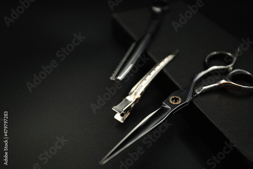 professional stylist tools lie on a black background