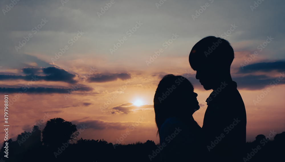 Couple man and woman hugging in love staying on outdoor with sunset scenery people romantic relationship and friendship concept.