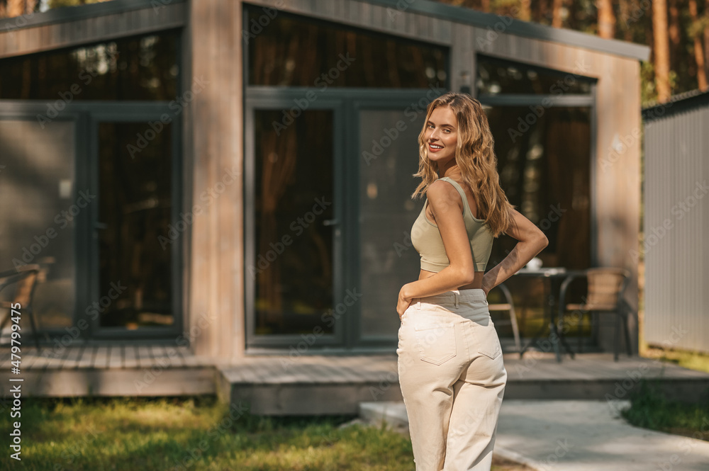 Pretty young blonde woman spending time outside and feeling relaxed