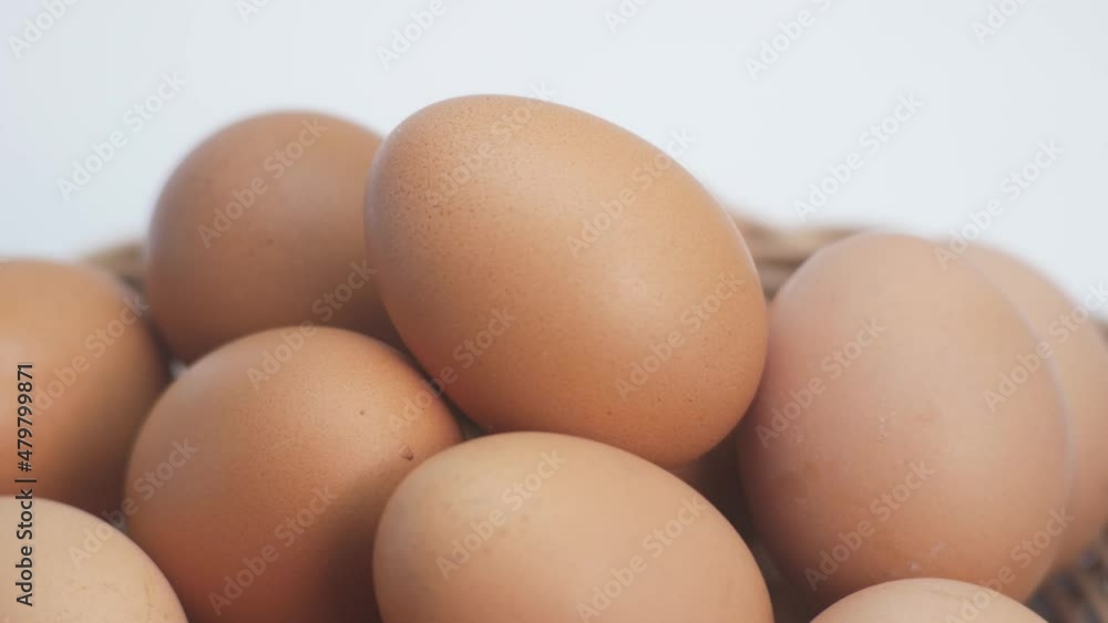 Closeup of Chicken egg rotates on white background. Rotating basket With Brown Eggs On Turntable.side view.Slowly Rotating video.Concept Fresh organic food.4K 2160p 30fps UltraHD footage Closeup of Chicken egg rotates on white background. Rotating basket With Brown Eggs On Turntable.side view.Slowly Rotating video.Concept Fresh organic food.4K 2160p 30fps UltraHD footage