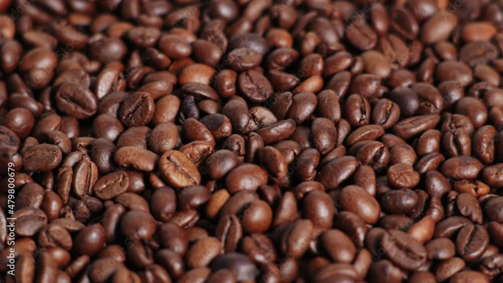 Coffee beans rotate slowly. Close up of dark Coffee Grains or Roasted arabica coffee bean.Top view.Rotating video.4K 2160p 30fps UltraHD footage Coffee beans rotate slowly. Close up of dark Coffee Grains or Roasted arabica coffee bean.Top view.Rotating video.4K 2160p 30fps UltraHD footage
