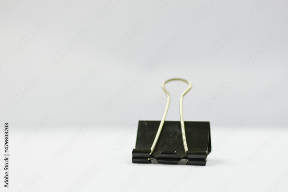 large black paper clip on white background