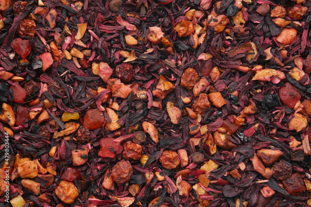 Background of natural fruit tea with hibiscus petals, fruit slices and berries. Fruit tea texture. Top view, flat lay. Background of natural fruit tea with hibiscus petals, fruit slices and berries. Fruit tea texture. Top view, flat lay.