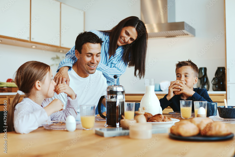 Smiling family having breakfast at home Smiling family having breakfast at home