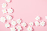 Beautiful flowers composition. Spring minimal concept. White flowers on pastel pink background. Valentines Day, Happy Women's Day. Flat lay, top view, copy space, banner