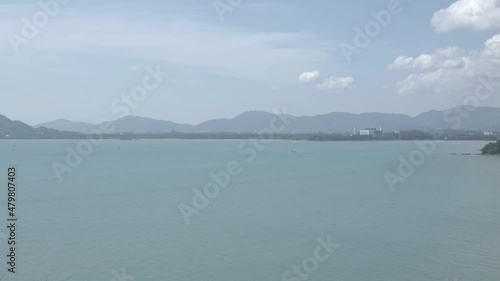 Phuket sea siray bay with mountain in background near phuket town in summer time photo