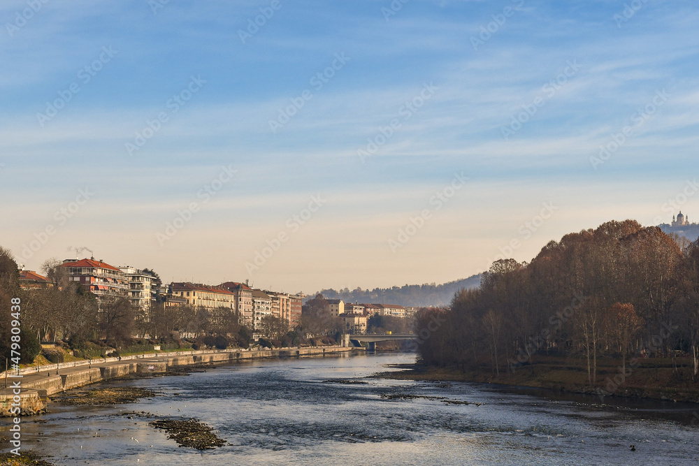 Scenic view of Lungo Po Luigi Cadorna riverside with Murazzi bank, the river park of Borgo Po district and the Basilica of Superga on the hilltop in winter, Turin, Piedmont, Italy
