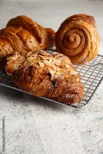 Close up of assorted pastries on a cooling rack on marble background photo