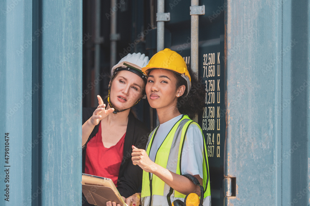 Team worker American women Work in an international shipping yard area Export and import delivery service with containers Team worker American women Work in an international shipping yard area Export and import delivery service with containers
