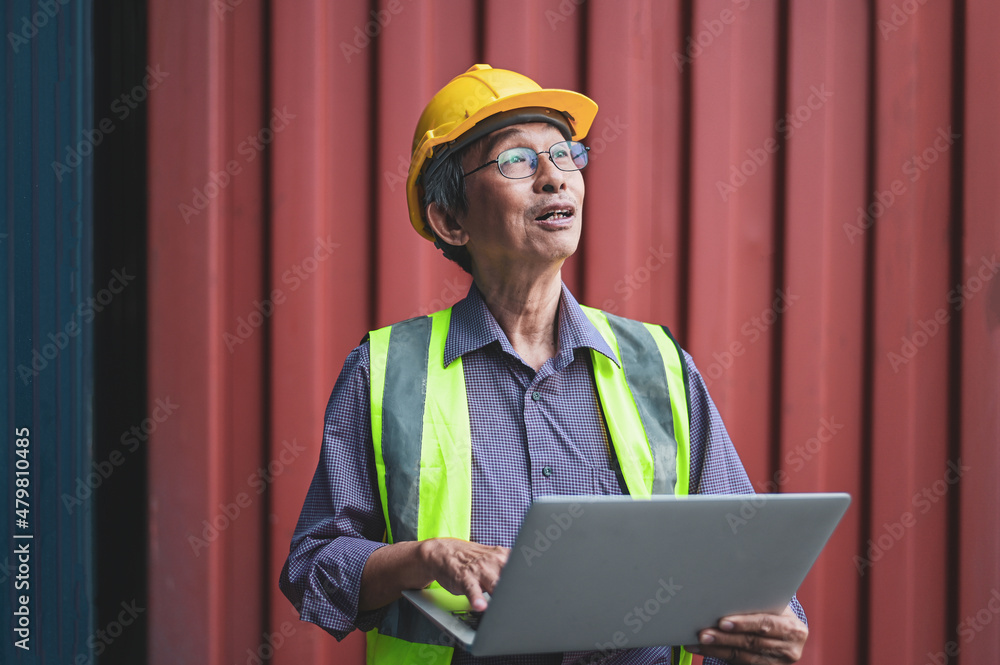 Portrait Senior Chinese business owner inspecting shipping containers to export products to foreign countries around the world Portrait Senior Chinese business owner inspecting shipping containers to export products to foreign countries around the world